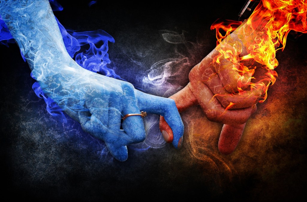 A hand with blue flames and a hand with red flames hold index fingers.